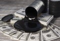 Spilled oil from a barrel to a dollar bill of money. Royalty Free Stock Photo