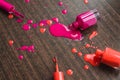 Spilled orange and pink nail polishes on wooden background. nail polish drops. Blot of nail polish on wooden background. Nail Poli