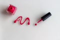 Spilled pink nail polish with bottle and brush on white background Royalty Free Stock Photo