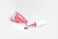 Spilled pink nail polish and brush on white background. Fashion woman still life. Pop female things Royalty Free Stock Photo