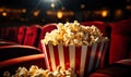 Spilled popcorn bucket on cinema seat with dramatic lighting in an empty movie theater, capturing the atmosphere of Royalty Free Stock Photo