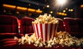 Spilled popcorn bucket on cinema seat with dramatic lighting in an empty movie theater, capturing the atmosphere of Royalty Free Stock Photo