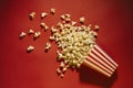 Spilled popcorn on a red background, cinema, movies and entertai Royalty Free Stock Photo
