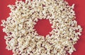 Spilled popcorn on a red background, cinema, movies and entertainment concept