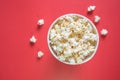 Spilled popcorn on a red background cinema movies and entertainment concept