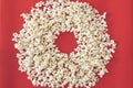 Spilled popcorn on a red background, cinema, movies and entertainment concept