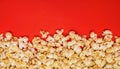 Spilled popcorn on a red background