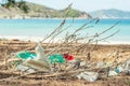 Spilled recycling garbage on beach of lazur sea. Used waste white foam and plastic bags. Environmental total pollution