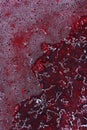 Spilled red paint on a thinner solution forming an abstract pattern. Royalty Free Stock Photo