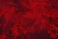 Spilled red paint on a thinner solution forming an abstract pattern. Royalty Free Stock Photo