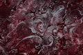 Spilled red and white paint on liquid thinner to form an abstract pattern. Royalty Free Stock Photo