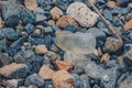 Spilled vivid multi colour garbage on stones background. Close up big plastic bottle. Environmental total pollution