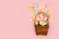 Spilling Easter basket of colorful pastel hand painted Easter Eggs and flowers Royalty Free Stock Photo