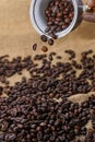 Spilling out coffee beans from cup Royalty Free Stock Photo