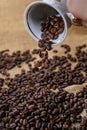 Spilling out coffee beans from cup Royalty Free Stock Photo