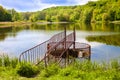 Spillway with metal railing on forest lake. Goloseevo, Kiev, Ukraine Royalty Free Stock Photo