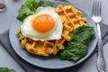 Spinach cheese waffles with fried egg on gray wooden background. Selective focus Royalty Free Stock Photo