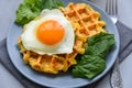 Spinach cheese waffles with fried egg on gray wooden background. Selective focus Royalty Free Stock Photo