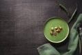 Spinach cream soup with croutons and chili peppers