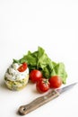 Spinach cupcakes with cheese cream frosting, green fresh onion on a white background with cherry tomatoes and spinach leaves