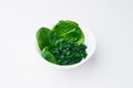 spinach fresh and freeze spinach blanch. on a white plate on a light background. Top view. Space for text. Mockup