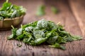 Spinach leaves.Fresh spinach leaves in retro bowl on oak wood board.