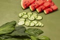 Spinach leaves, sliced cucumbers and watermelon wedges