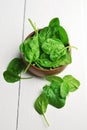 Spinach leaves in wooden bowl on white wooden table background. Healthy vegan food trend. Vegan lifestyle concept. Royalty Free Stock Photo