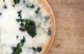 Spinach mushroom pizza on a cutting board Royalty Free Stock Photo