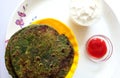 Spinach Paratha flatbread Indian cuisine served with traditional Punjabi Dahi and Chutney Royalty Free Stock Photo