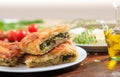 Spinach pie pieces on a table