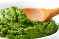 Spinach puree and wooden spoon