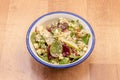Spinach salad with beetroot slices, pear thin slices, crumbled blue cheese, pieces of nuts inside an enameled metal bowl Royalty Free Stock Photo