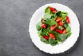 Spinach salad with pepper and tomatoes in white plate Royalty Free Stock Photo