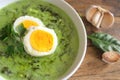 Spinach soup with boiled egg. Top view.