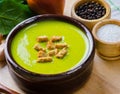 Spinach soup served on wooden board Royalty Free Stock Photo