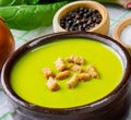 The spinach soup served on wooden board Royalty Free Stock Photo