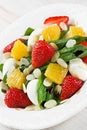 Spinach strawberry orange quail eggs salad with almonds slices