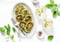 Spinach, zucchini, green peas, garden herbs fritters and white wine on a light background, top view. Tasty appetizers, snack, tapa