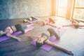 Spinal twist. Five young sport women are stretching in modern st