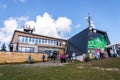 People walk around Medvedin mountain chairlift top station on sunny summer day Royalty Free Stock Photo