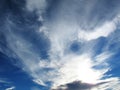 Spindrift clouds on blue sky before sunset