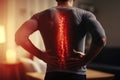 Spine discomfort, Man with backache at home, lower back injury, red spot Royalty Free Stock Photo