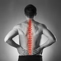 Spine pain, man with backache and ache in the neck, black and white photo with red backbone Royalty Free Stock Photo