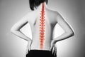 Spine pain, woman with backache and ache in the neck, black and white photo with red backbone Royalty Free Stock Photo