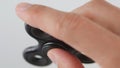 Spinner or fidgeting hand toy rotating on man`s hand