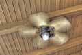 Spinning ceiling fan with light on rustic wood ceiling Royalty Free Stock Photo