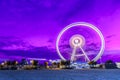 Spinning ferris wheel at sunrise blue hour in Rimini, Italy. Long exposure abstract image Royalty Free Stock Photo