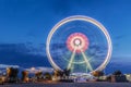 Spinning ferris wheel at sunrise blue hour in Rimini, Italy. Long exposure abstract image Royalty Free Stock Photo