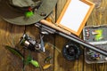 Spinning, fly fishing, flies, spinners, hat and frame for your label lying on a wooden table. Royalty Free Stock Photo